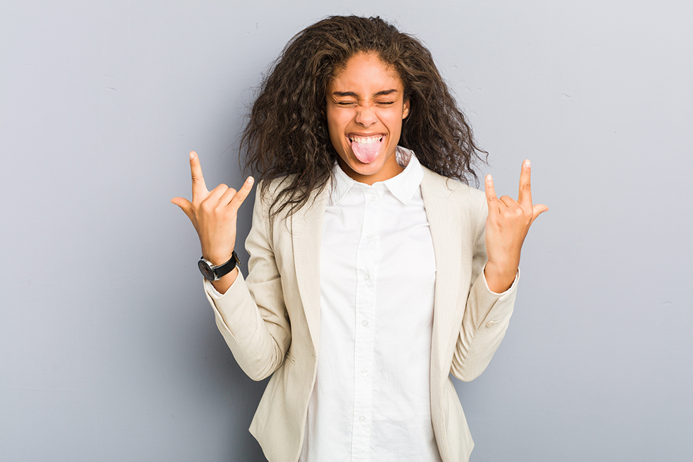 Black business woman with rock fingers